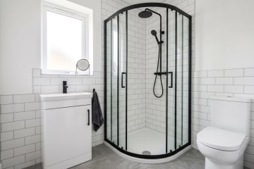 an image showing a black quadrant enclosure fitted into small bathroom | Article Image